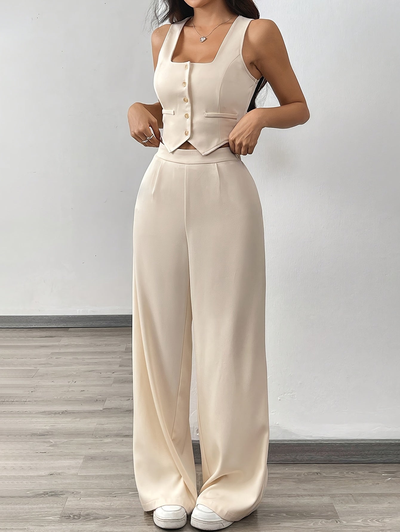 A Set Consisting of Two Women'S Apricot-Colored Sleeveless Cardigans with Square Necklines And Loose-Fitting Wide-Leg Pants.